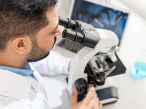 beche doctor looking into microscope